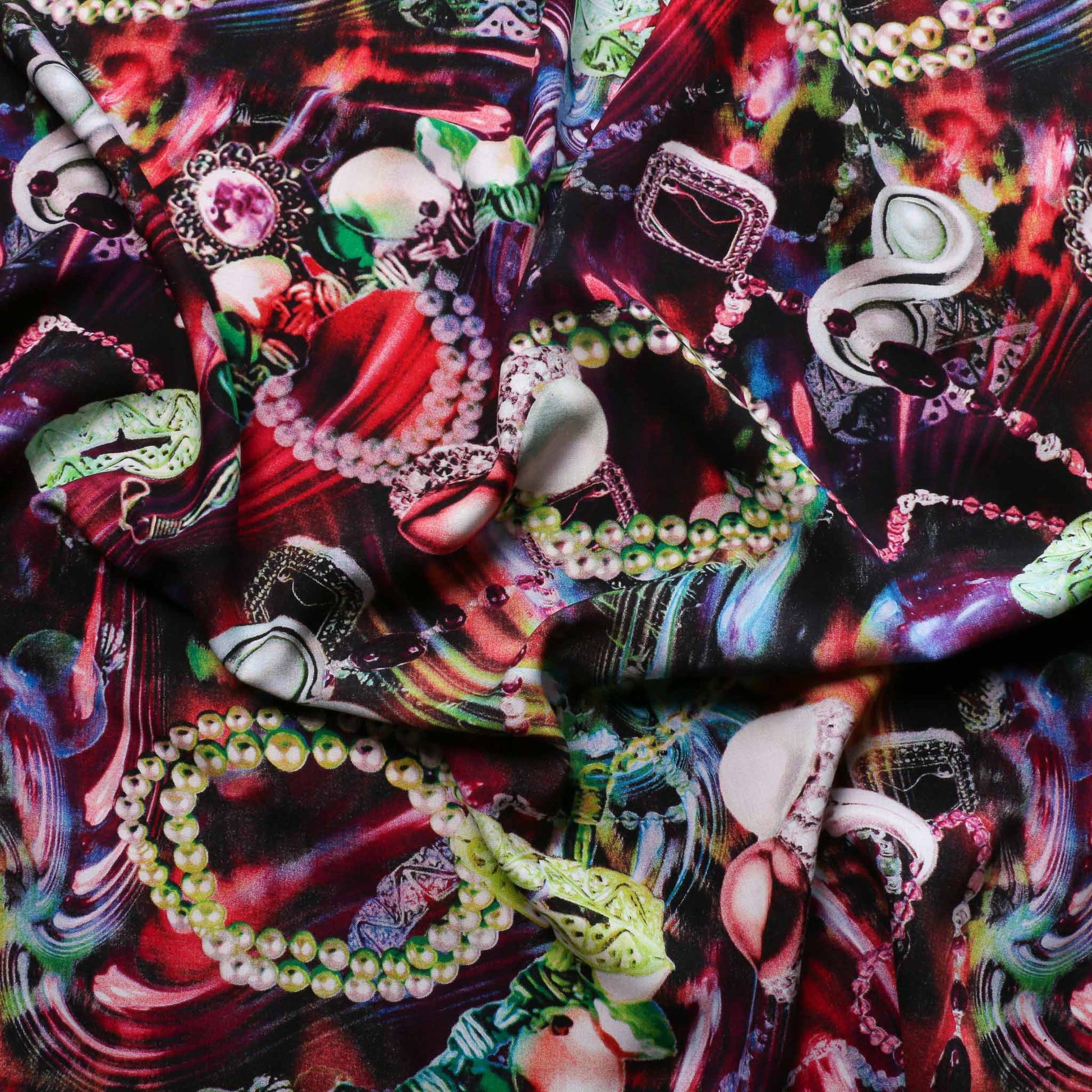 viscose challis dressmaking fabric in pink and red with printed jewellery pattern