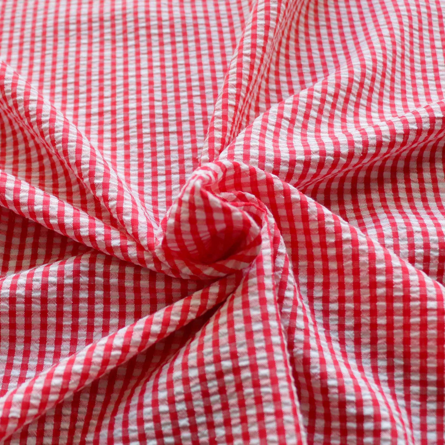 red and white seersucker gingham dressmaking fabric with gingham design