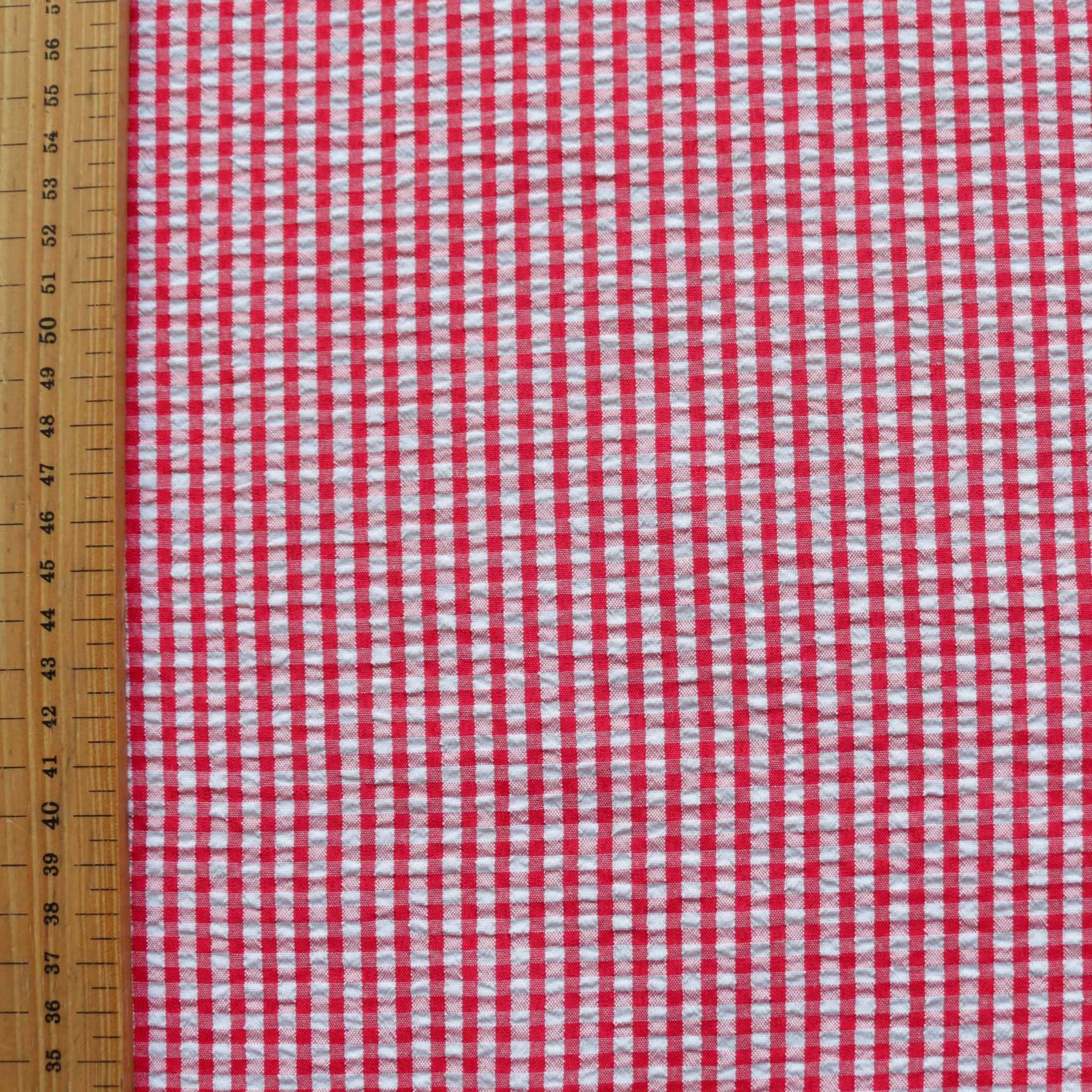 metre seersucker gingham dressmaking fabric in red and white