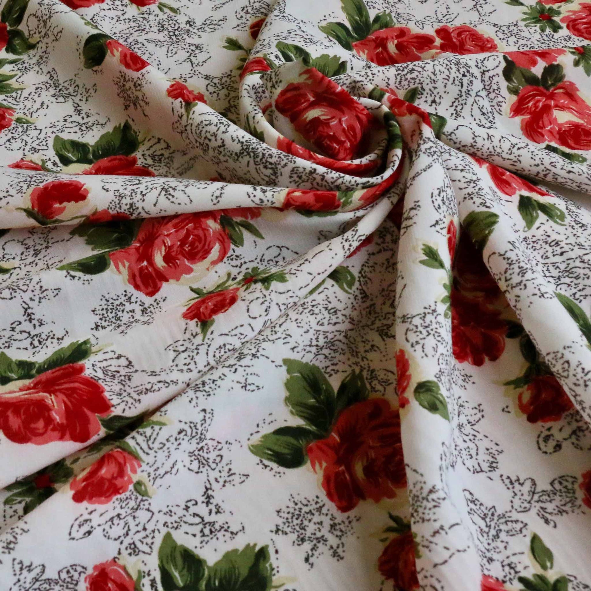 white chiffon stretchy polyester dressmaking fabric with red rose floral print
