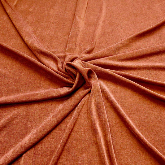 rust orange coloured jersey slinky dressmaking fabric