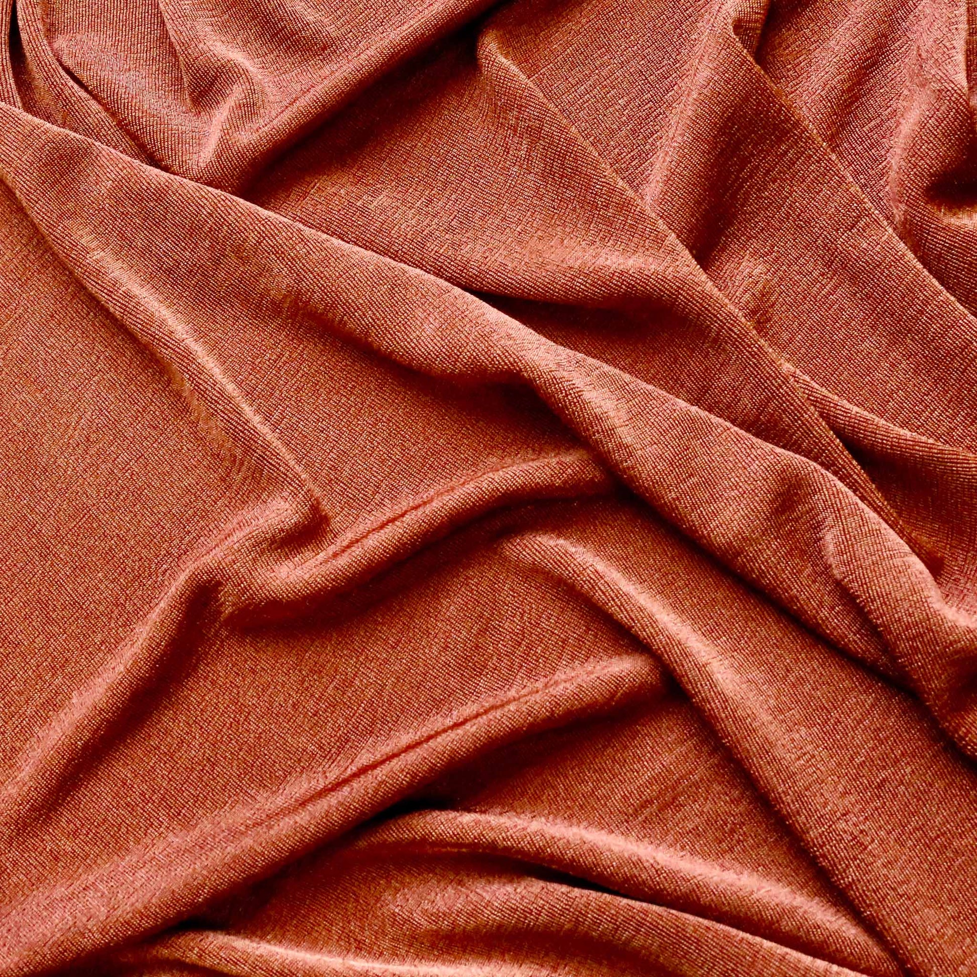 slinky jersey dressmaking fabric in plain stretch rusty orange colour