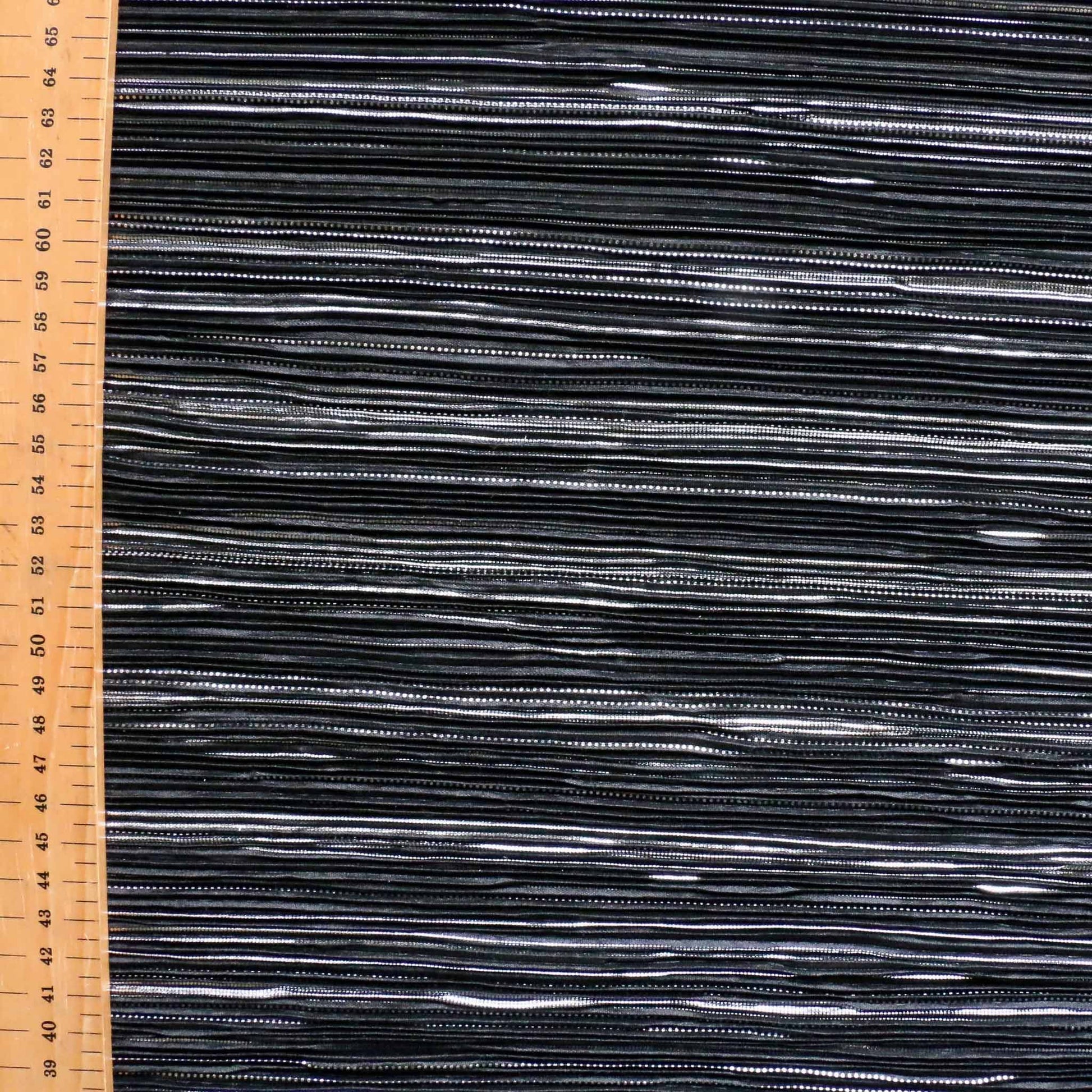 metre black pleated plisse dressmaking fabric with silver pattern design
