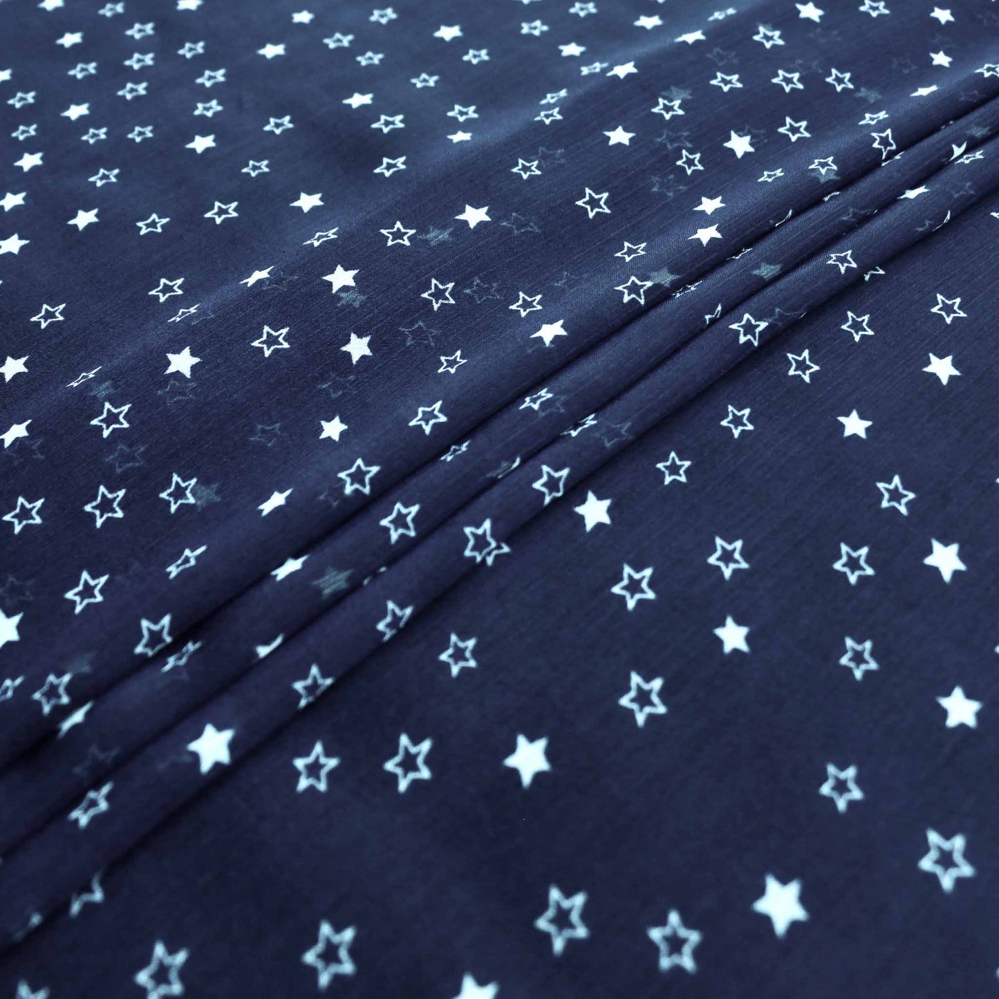 blue chiffon crinkle dressmaking fabric with white stars design print