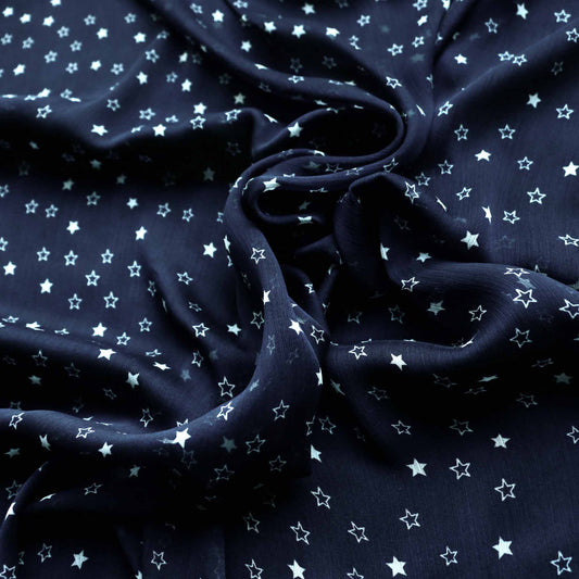 white stars on blue chiffon dressmaking fabric