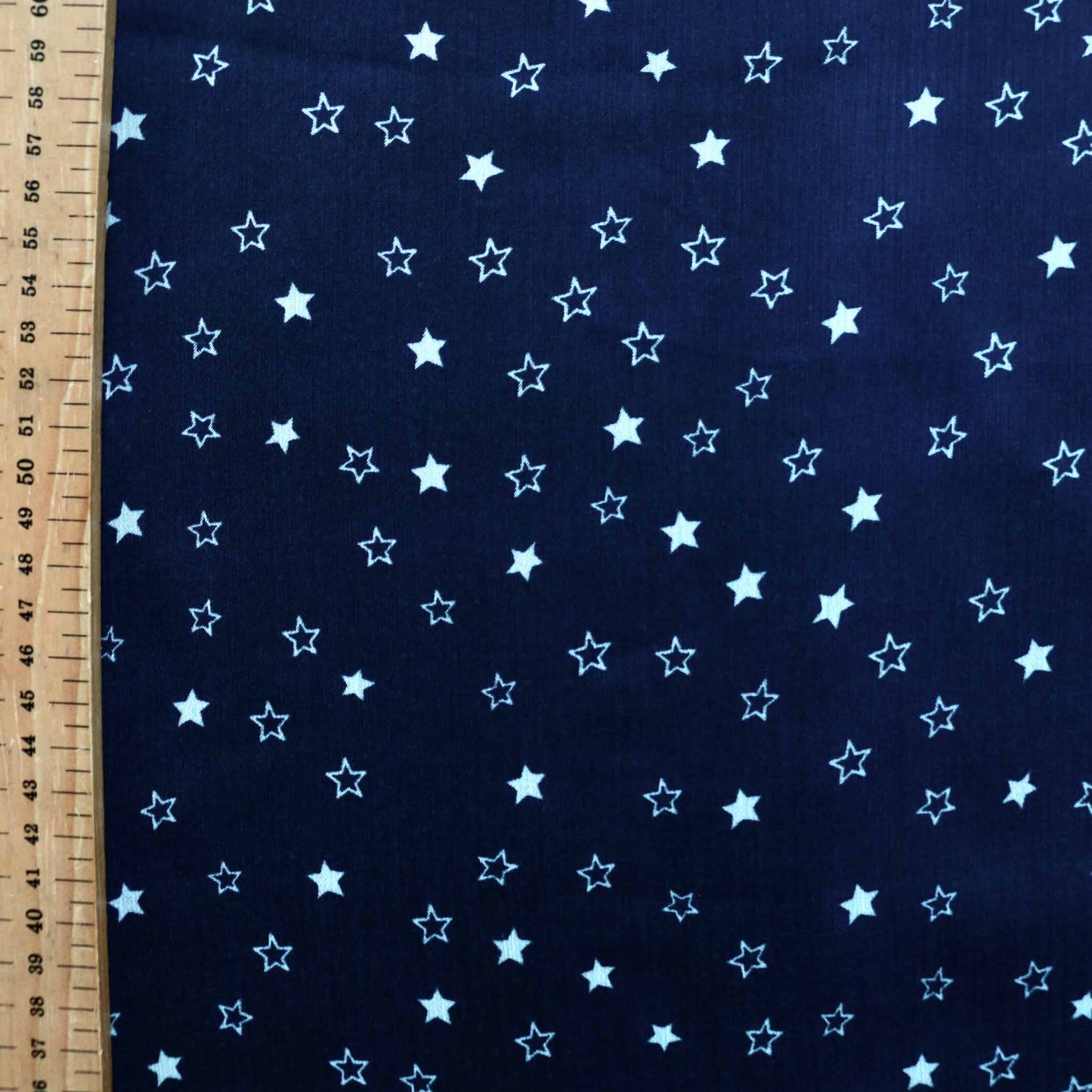 white stars printed on blue crinkle chiffon polyester dressmaking fabric