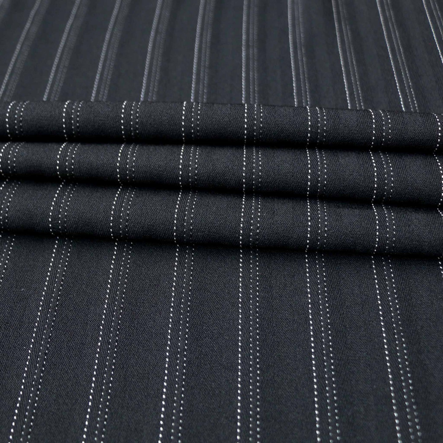 white dotted pinstripe on black stretchy suiting dressmaking fabric