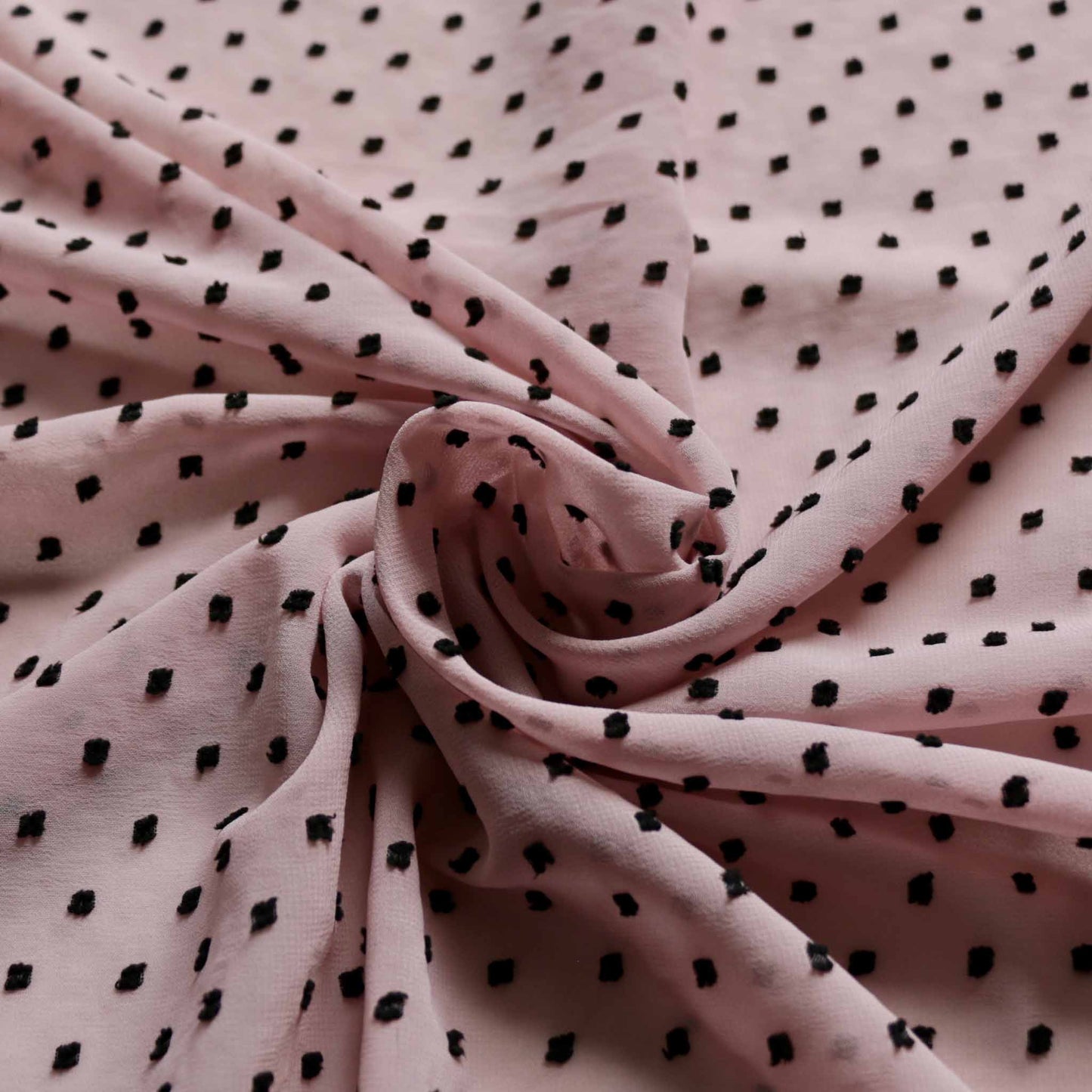 black swiss dot dobby on pink chiffon dressmaking fabric