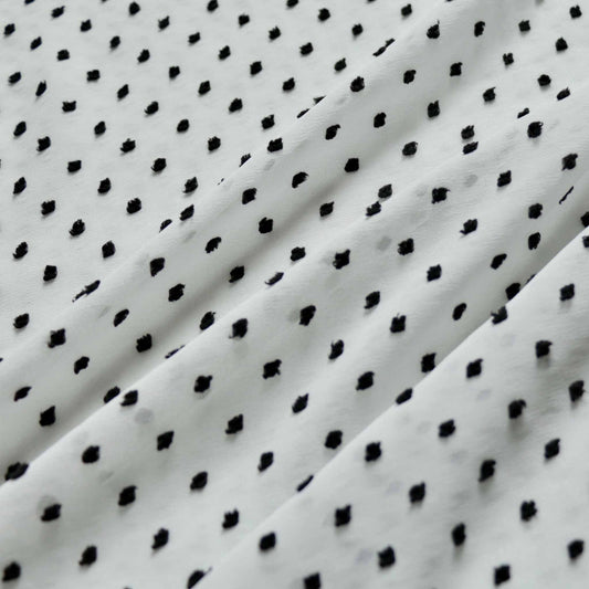 white chiffon dressmaking fabric with black swiss dot dobby pattern