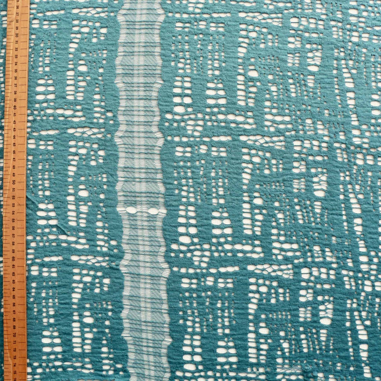 metre turquoise dressmaking lace fabric with embroidery effect and abstract design
