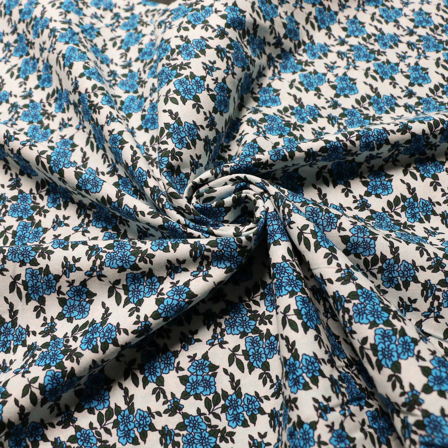 light blue sustainable vintage cotton dressmaking poplin fabric with blue floral print
