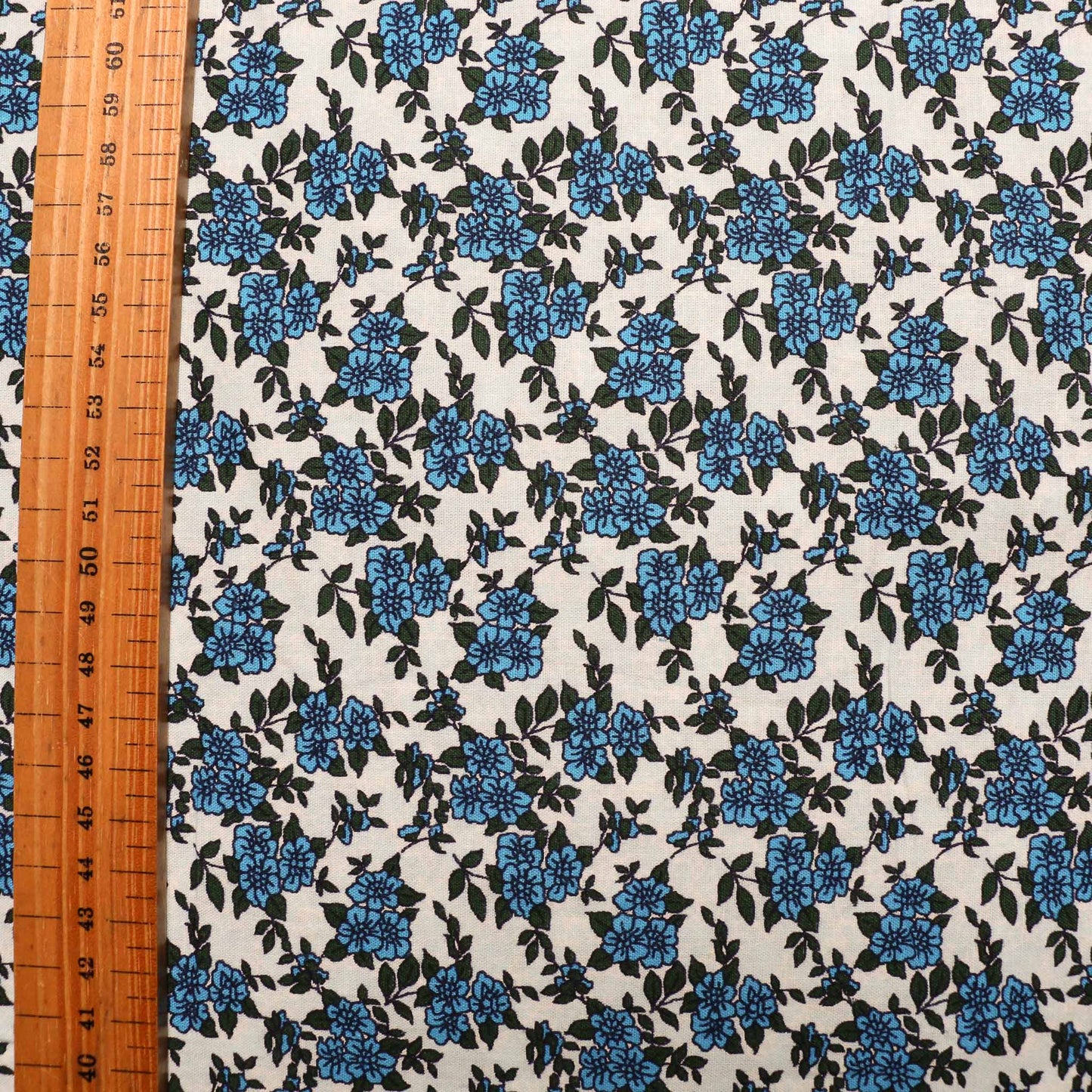 folded pale blue vintage cotton poplin deadstock sustainable fabric with printed floral pattern