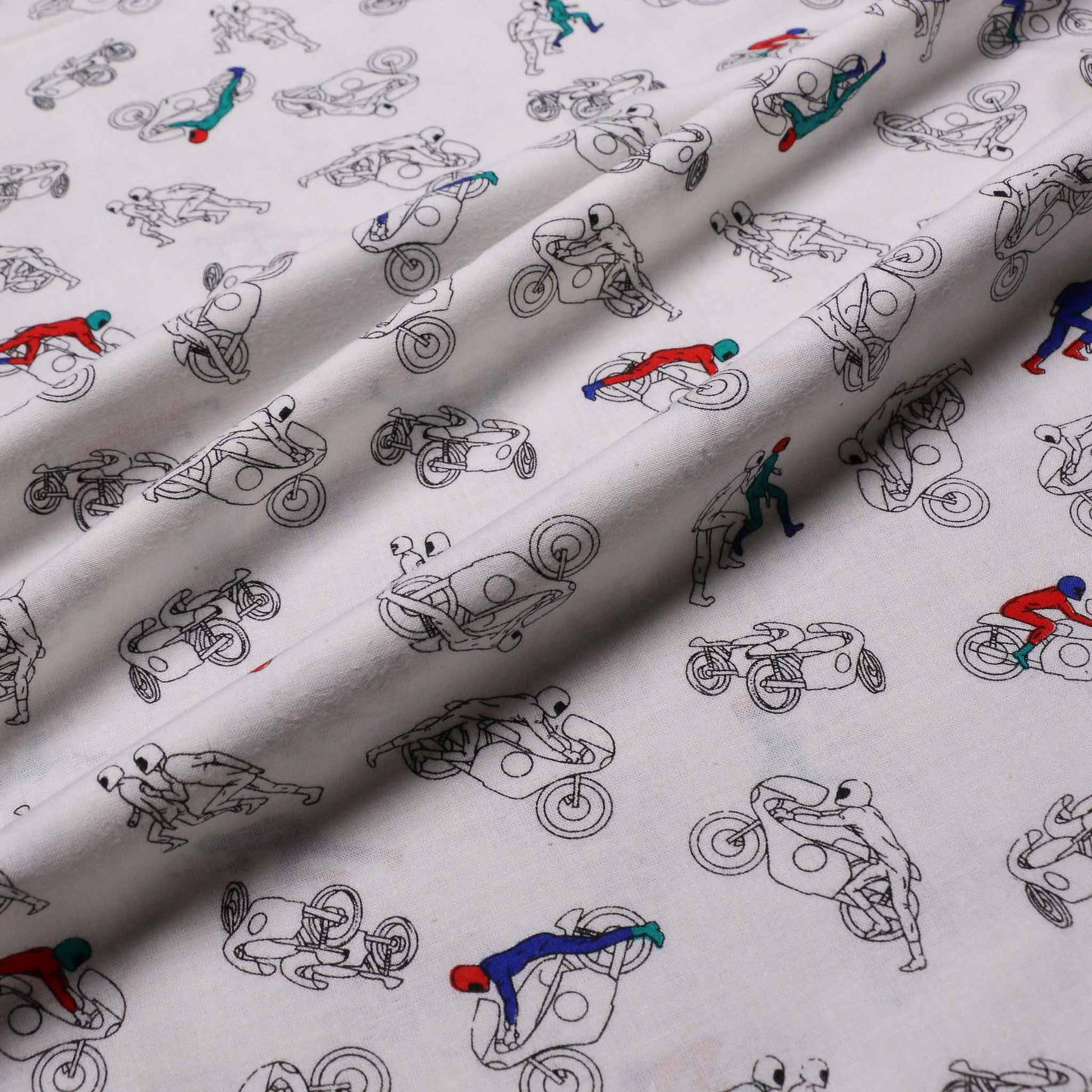 brushed cotton dressmaking fabric in white colour and motocross print