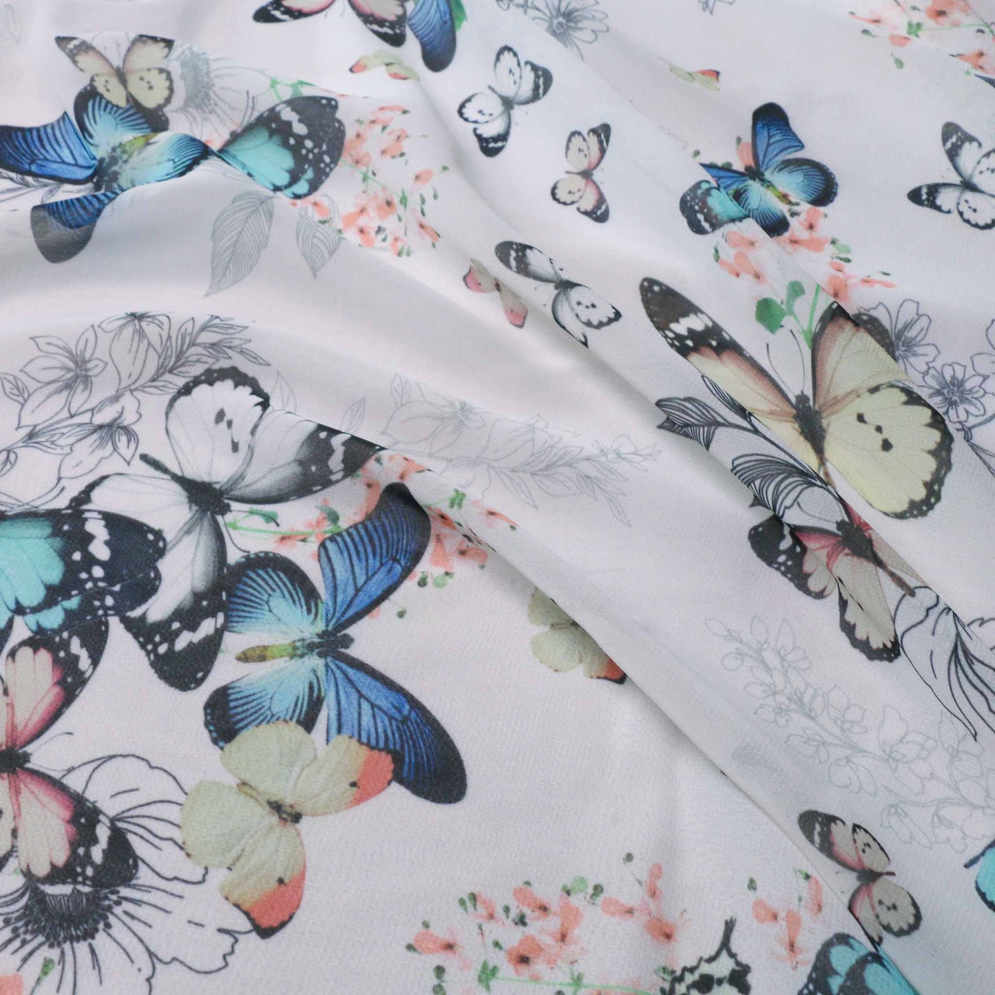 blue yellow and pink butterflies printed on white chiffon dressmaking fabric