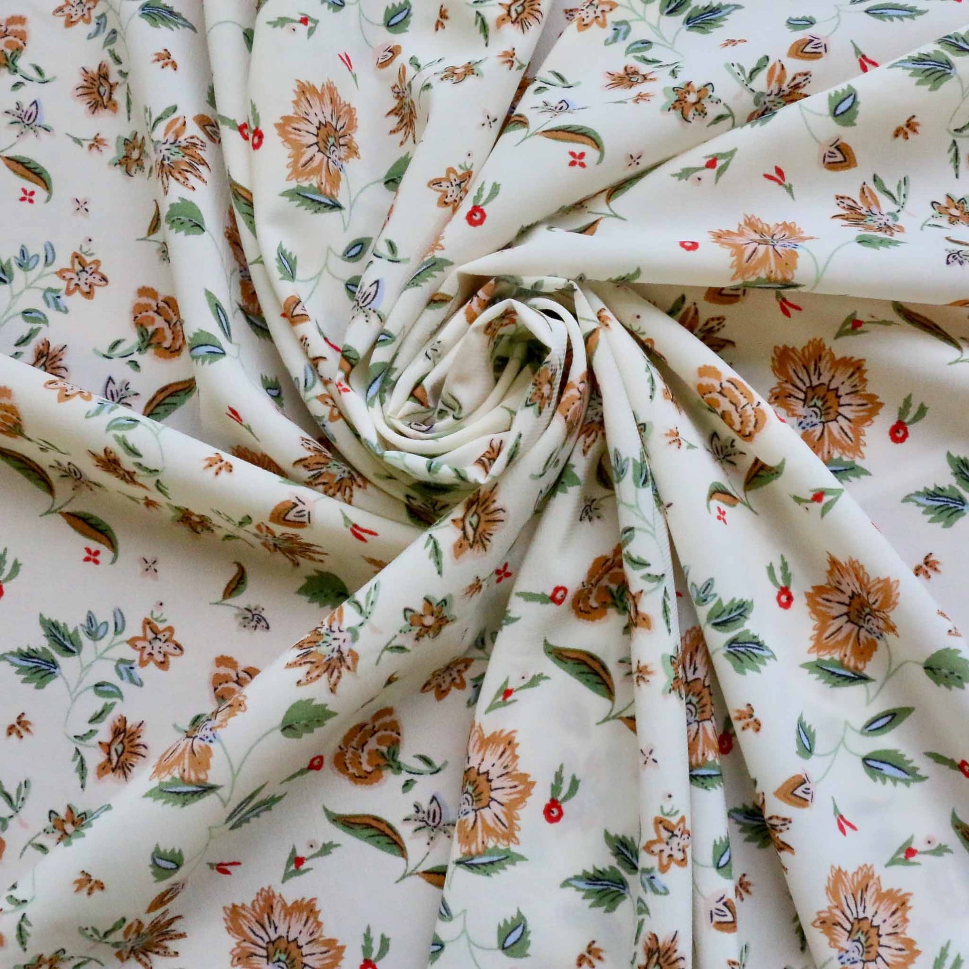 white floral stretchy chiffon dressmaking fabric with brown and green floral design