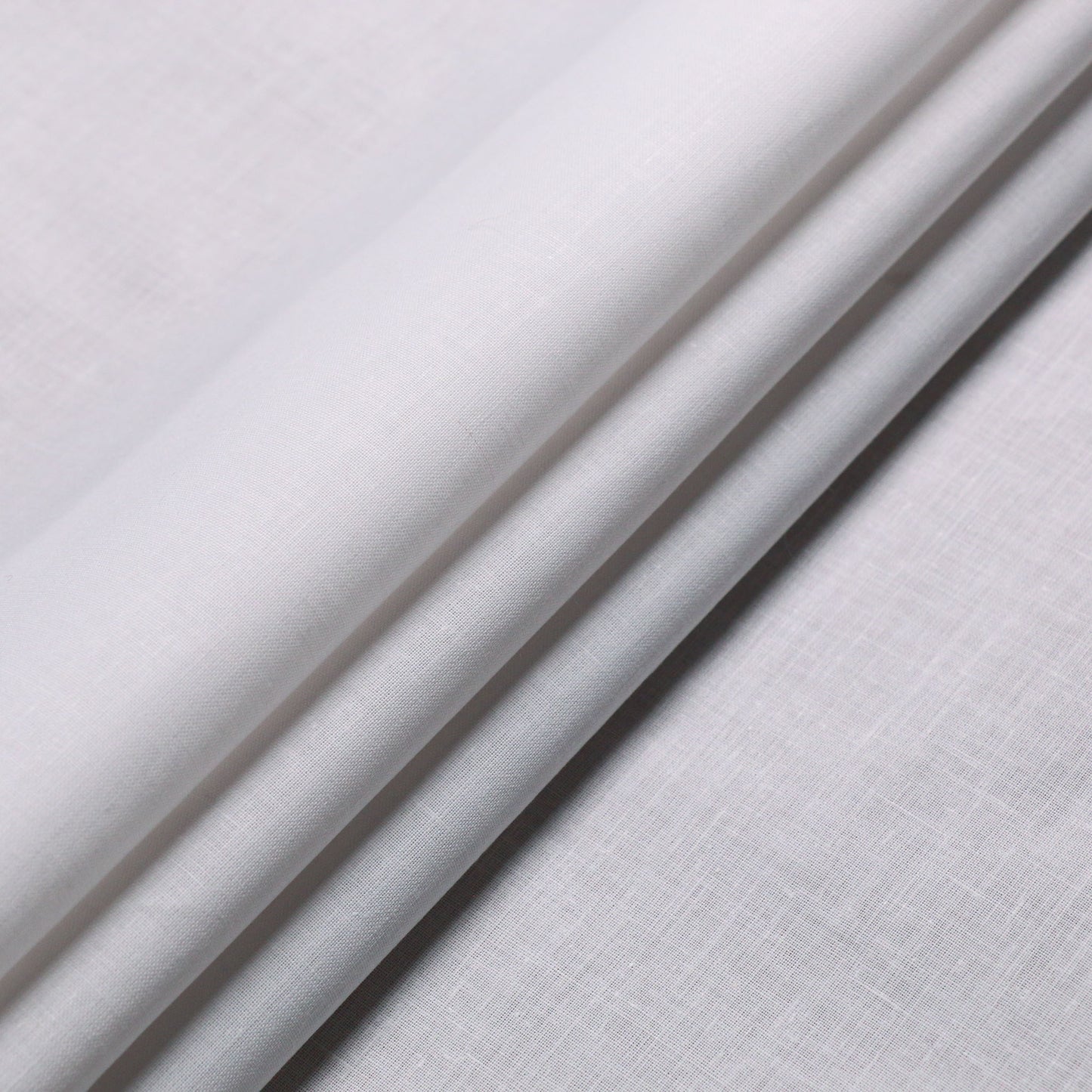 plain white folded cotton dressmaking fabric