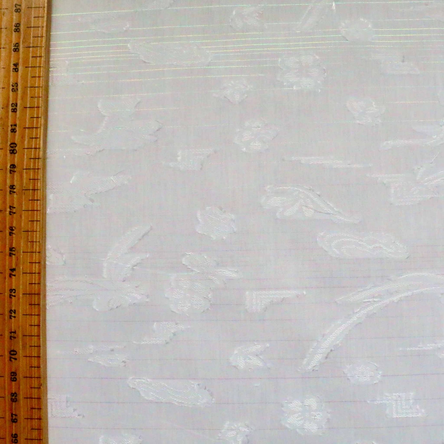 metre flocked white dressmaking polycotton with clipped floral pattern