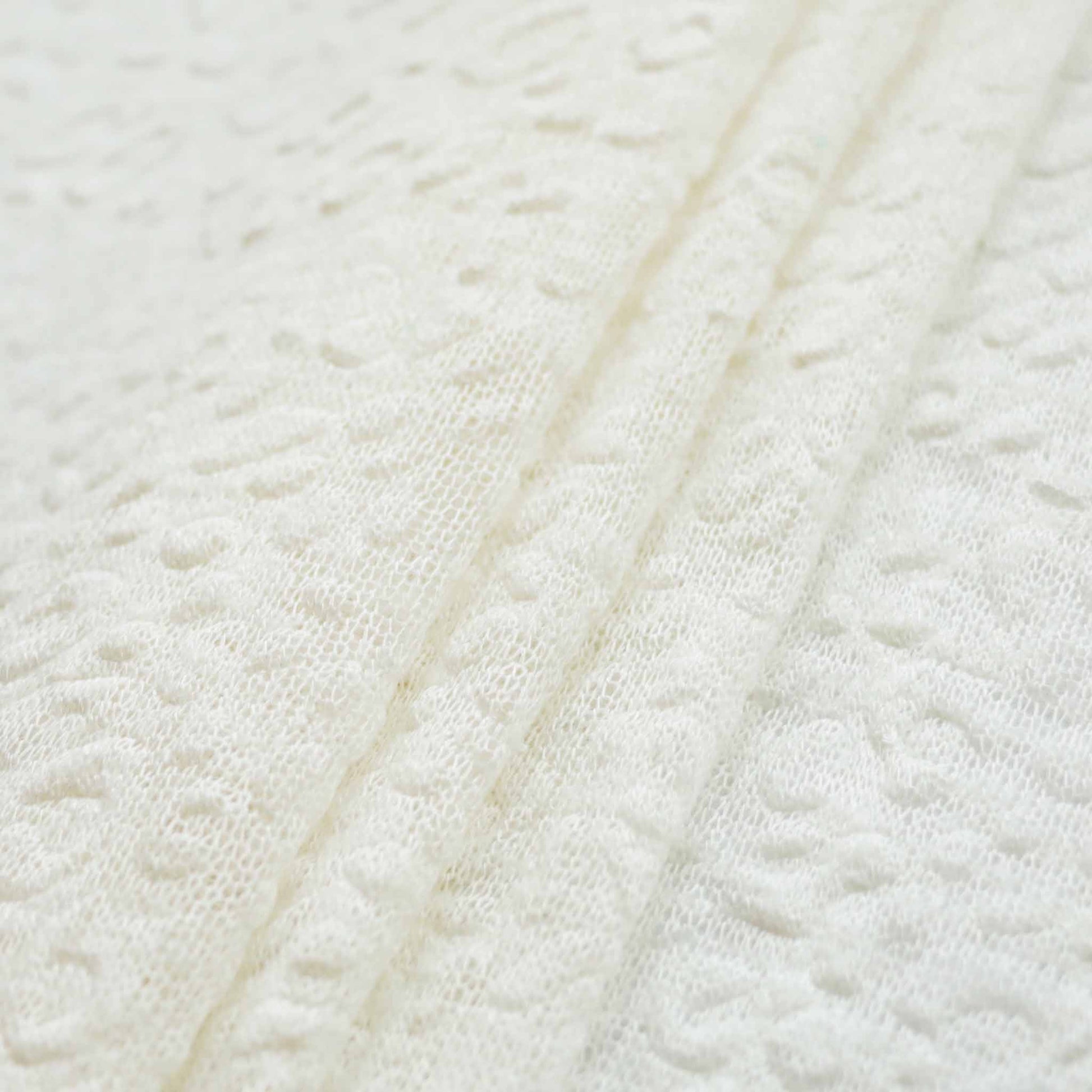 embossed white jersey knit dressmaking fabric