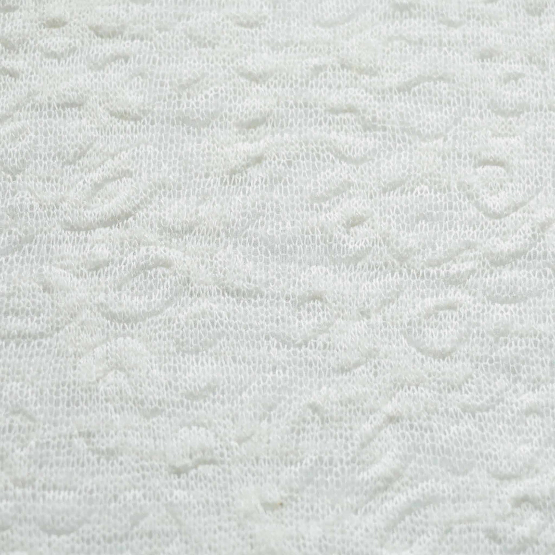 white jersey dressmaking fabric with embossed pattern texture