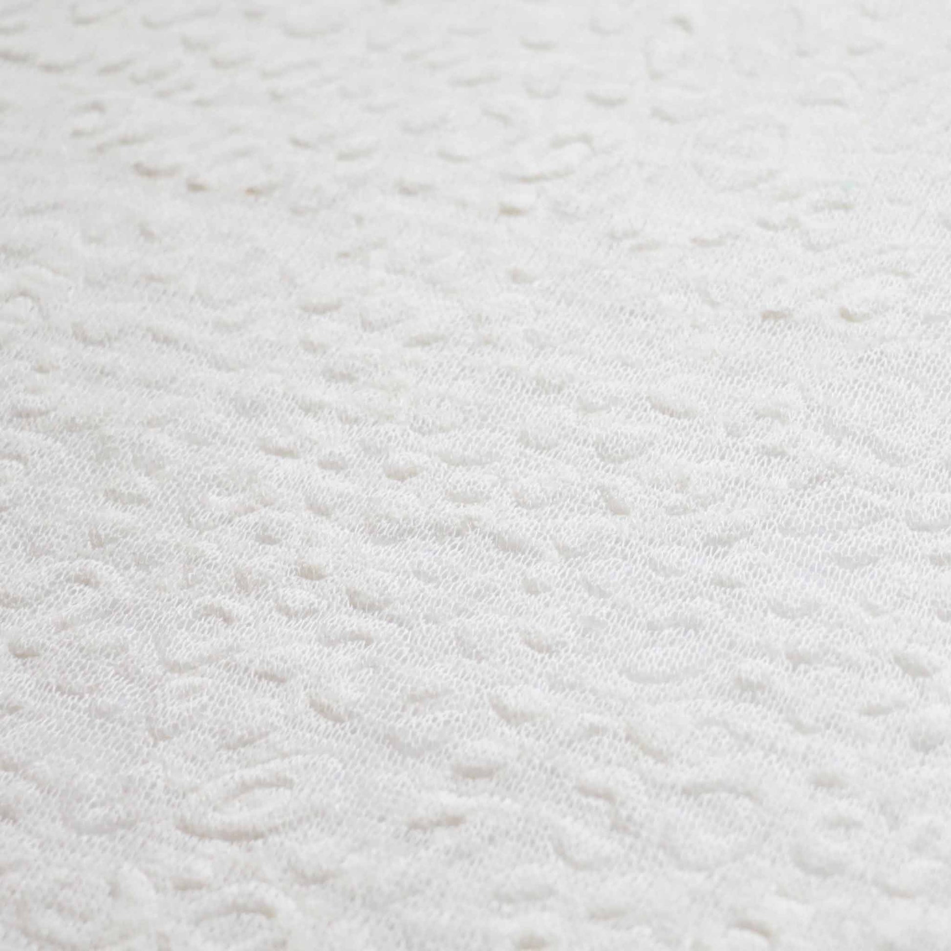 white embossed textured jersey knit dressmaking fabric