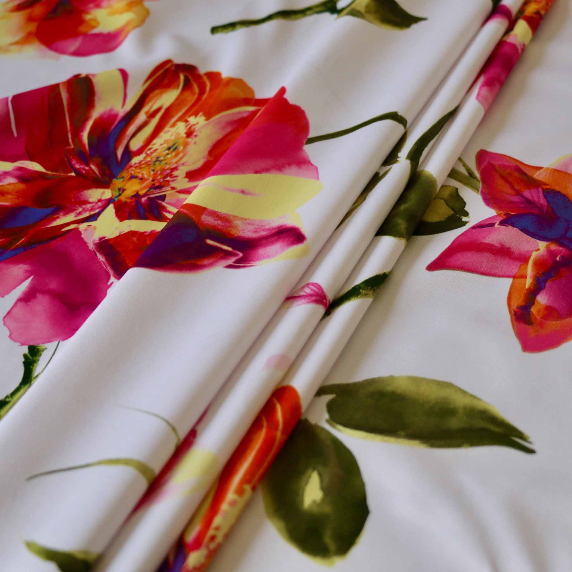 jersey lycra dressmaking fabric in white with colourful magnolia flower print