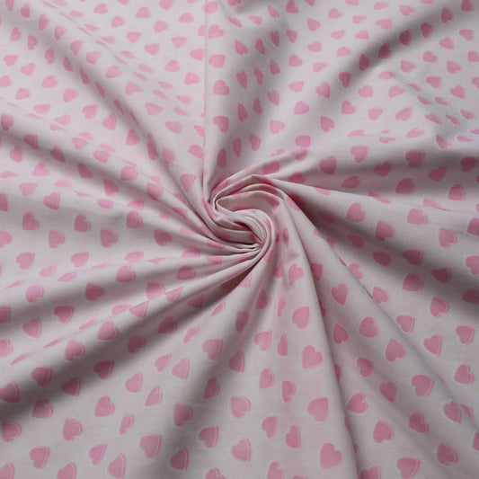 white polycotton dressmaking fabric with pink colour love hearts print