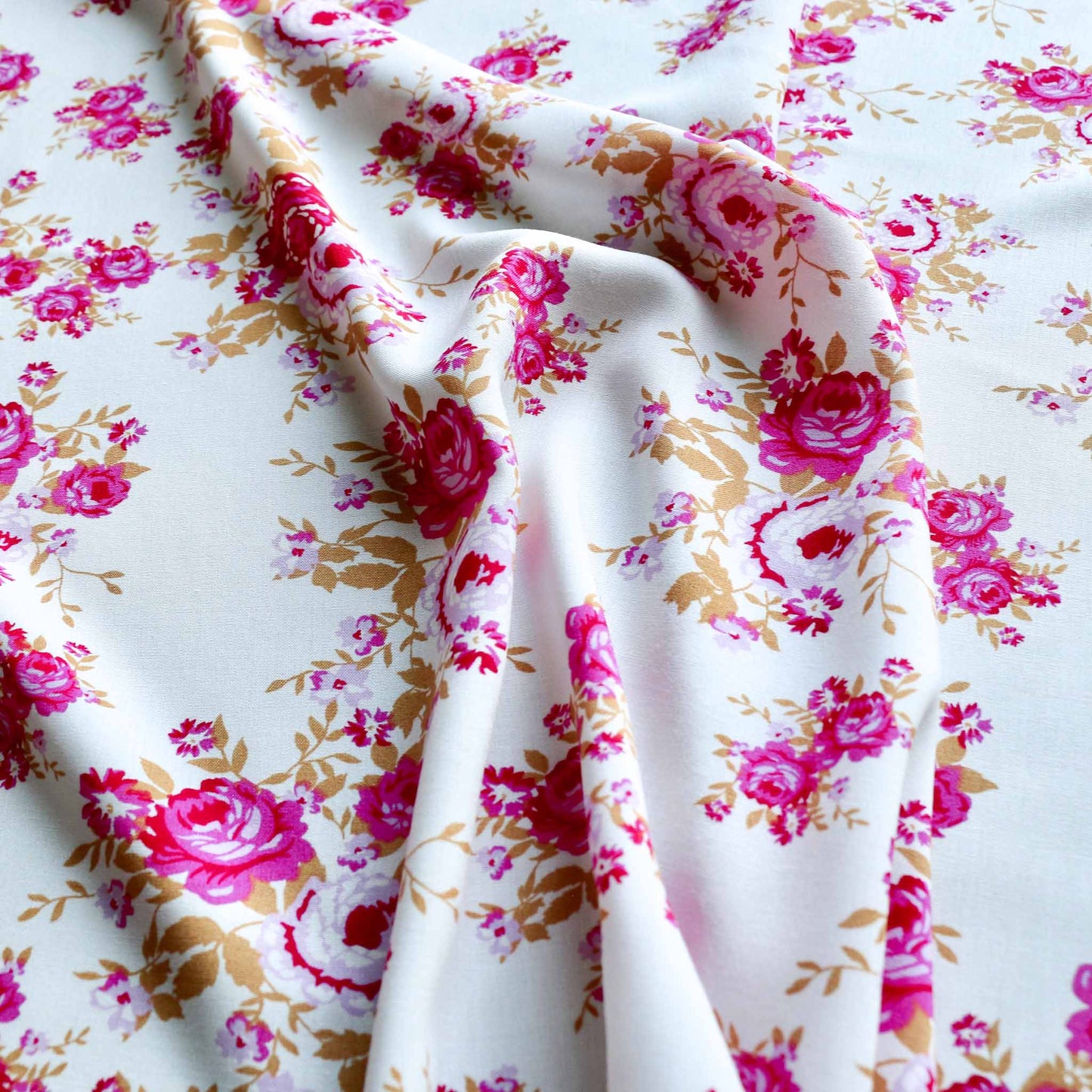 white viscose challis dressmaking fabric with pink roses delicate floral print