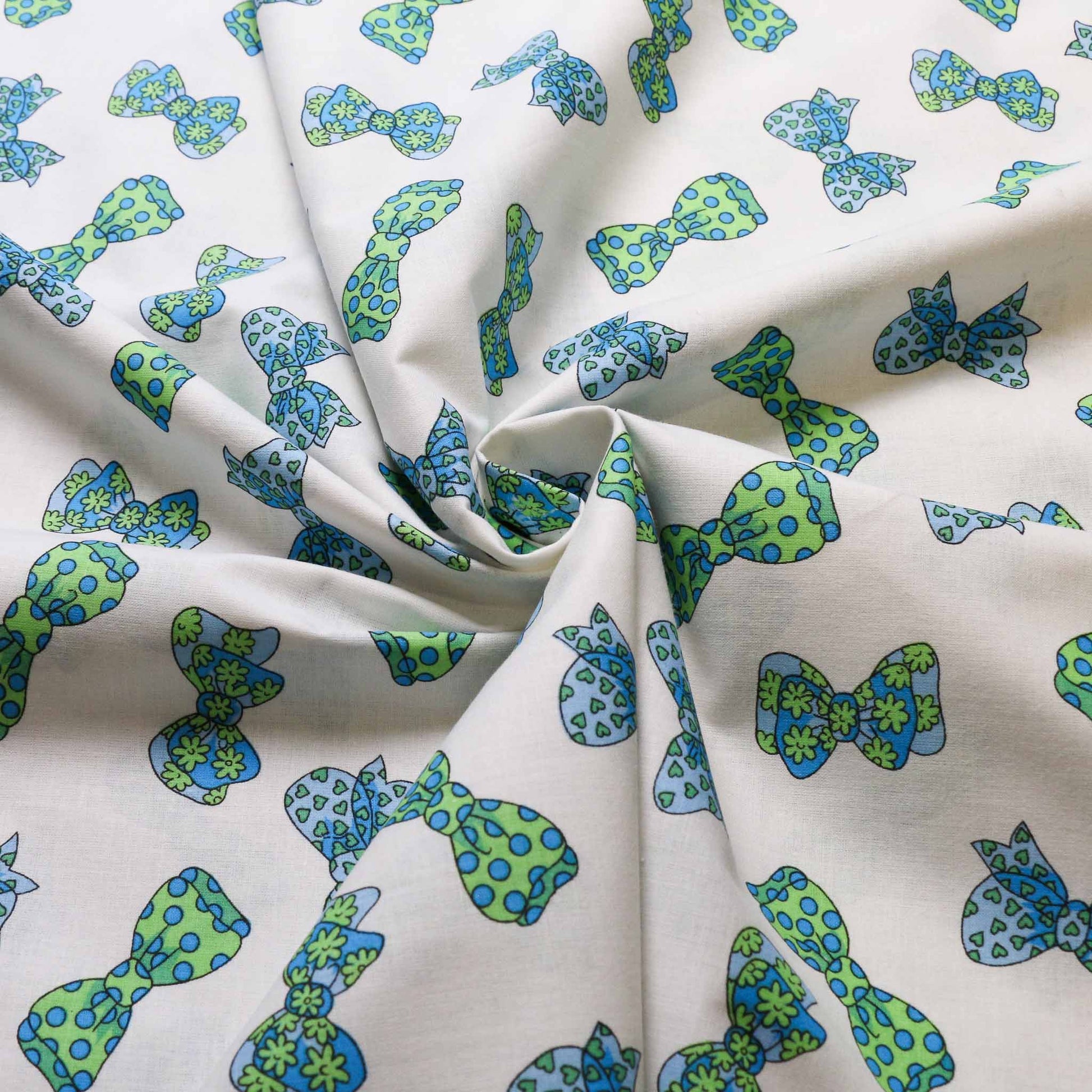cotton deadstock retro fabric in white with green polka dot printed bow tie design from cloth control