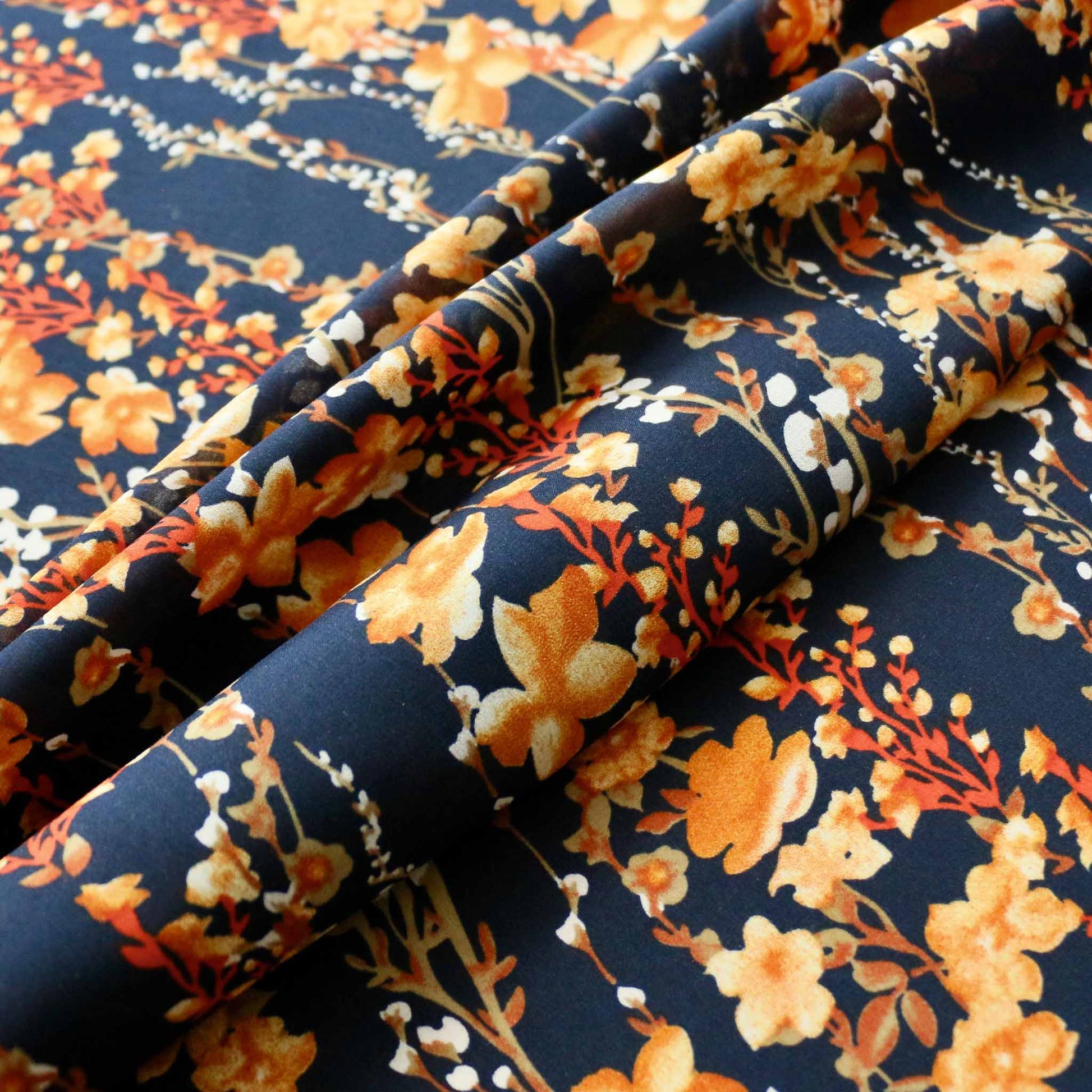 yellow floral print on blue stretchy chiffon dressmaking fabric
