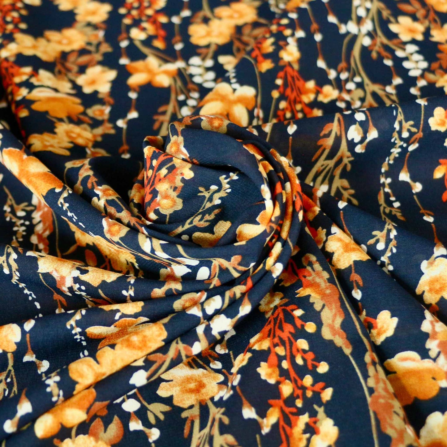 golden yellow floral print on blue stretchy chiffon dressmaking fabric