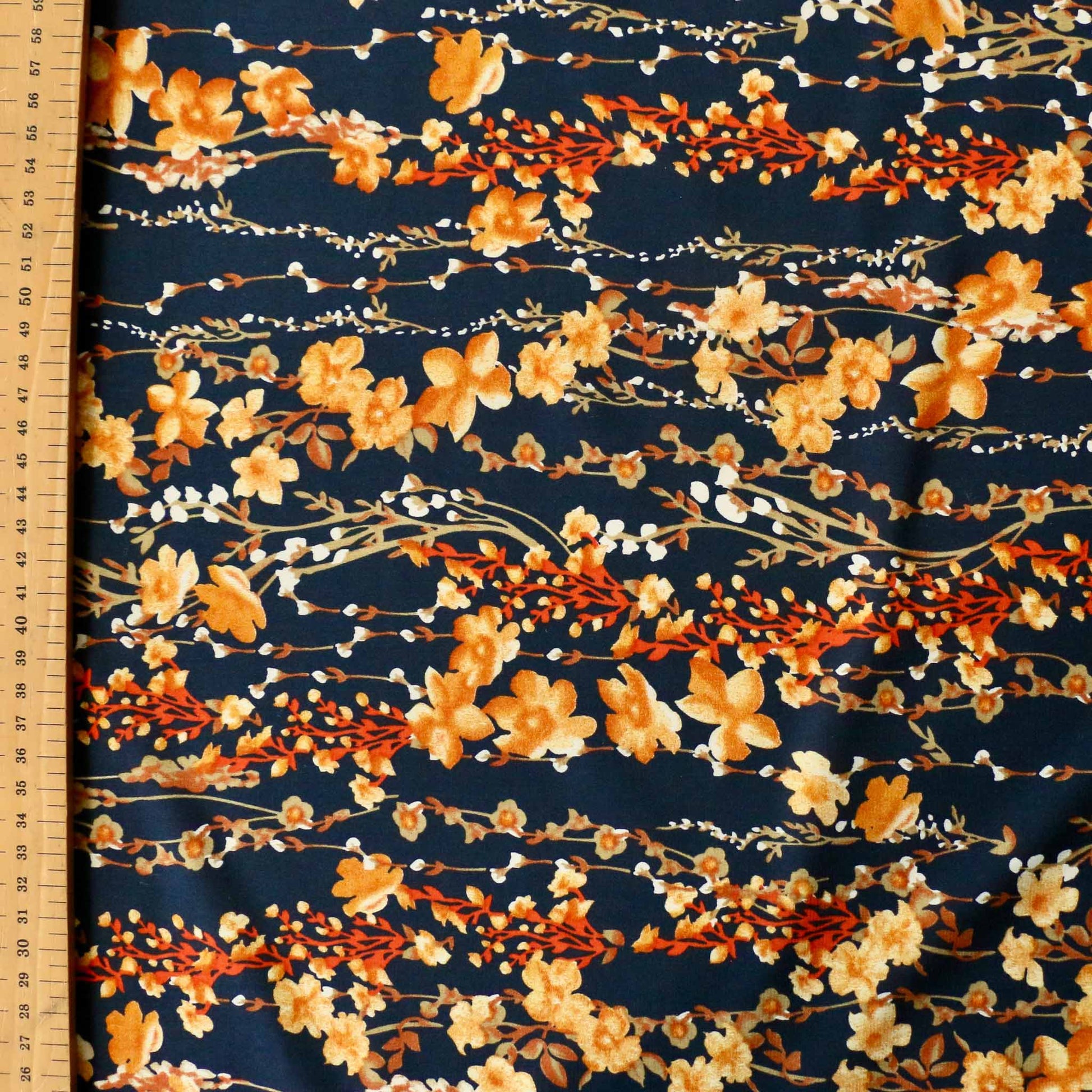metre blue stretchy chiffon dressmaking fabric with golden yellow nature inspired floral print
