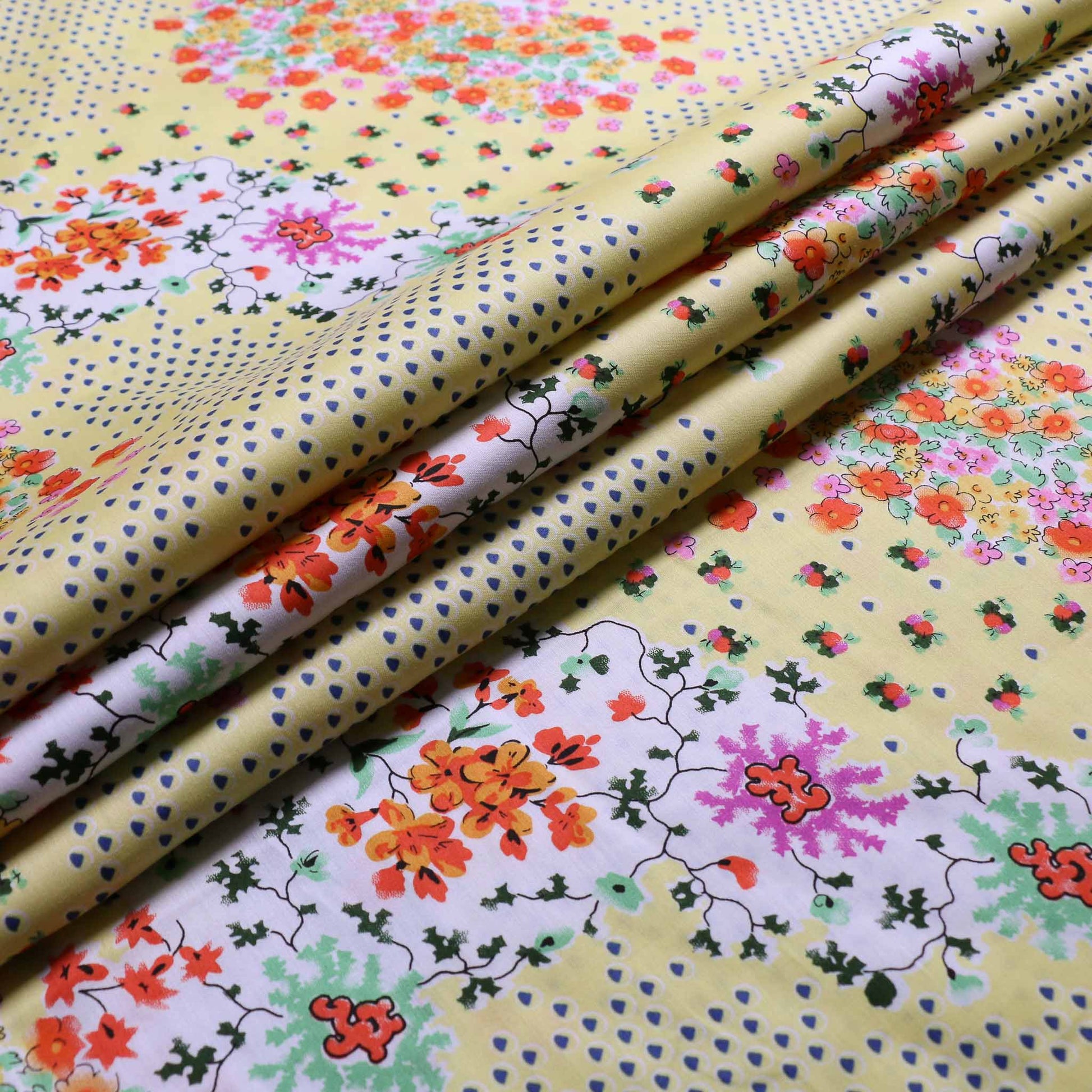pastel yellow cotton lawn fabric with printed multicoloured floral pattern